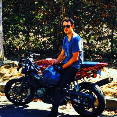 Sean Harmon posing with his luxurious sports bike.